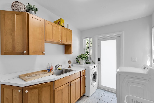 washroom featuring cabinets, light tile patterned flooring, sink, and washing machine and clothes dryer