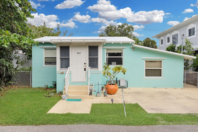 view of front of house with a patio and a front yard