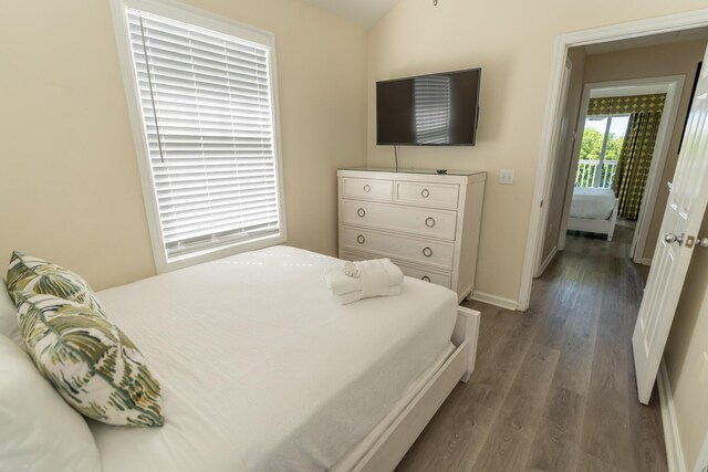 bedroom with dark hardwood / wood-style flooring