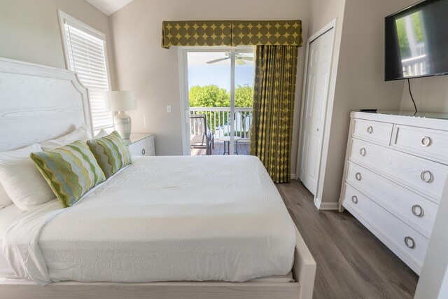 bedroom with access to exterior, dark hardwood / wood-style flooring, and a closet