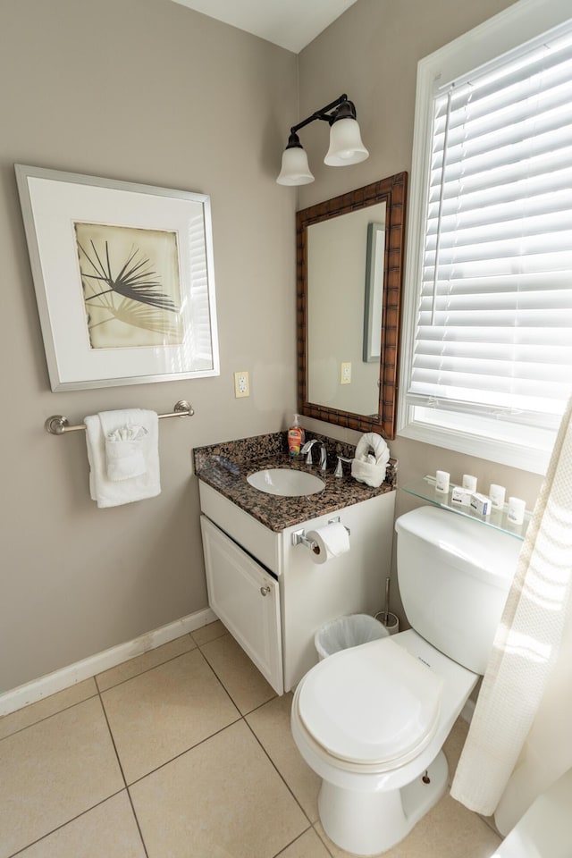 bathroom featuring tile patterned floors, vanity, and toilet