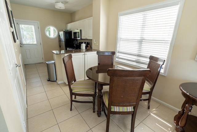 dining space featuring light tile patterned floors