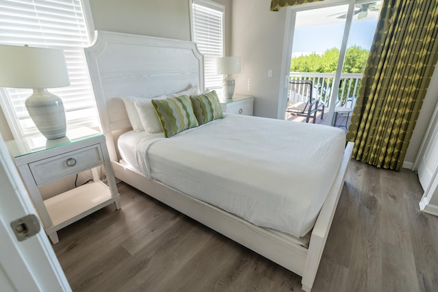 bedroom featuring dark hardwood / wood-style flooring and access to outside