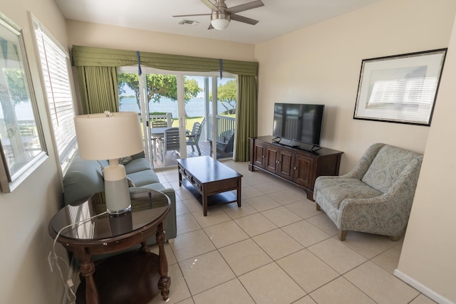 living room featuring ceiling fan and light tile patterned flooring