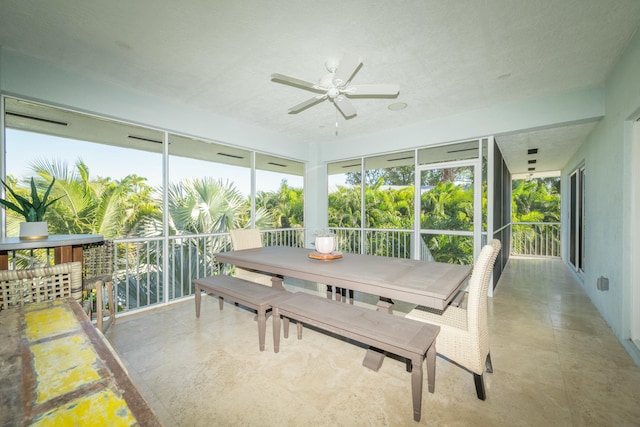 sunroom featuring a ceiling fan