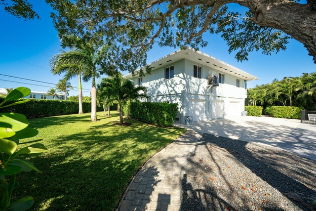 view of property exterior with a garage and a yard