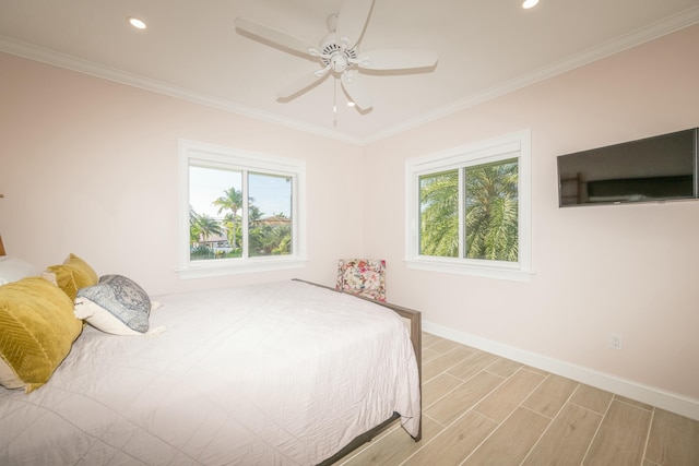 bedroom with multiple windows, wood finished floors, and crown molding