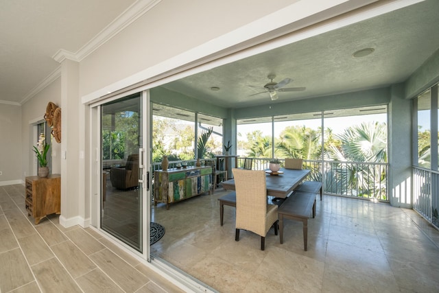 sunroom / solarium featuring ceiling fan