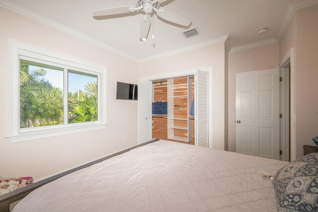 bedroom with ornamental molding and ceiling fan