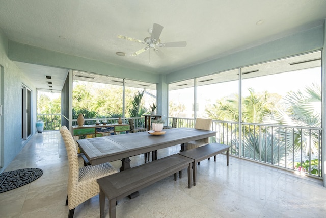 sunroom / solarium featuring ceiling fan