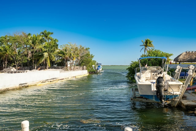 dock area with a water view and boat lift