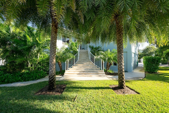 surrounding community featuring stairway and a lawn