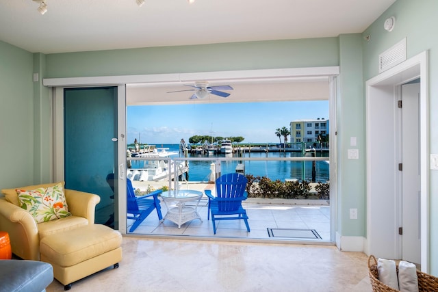 interior space featuring ceiling fan and a water view