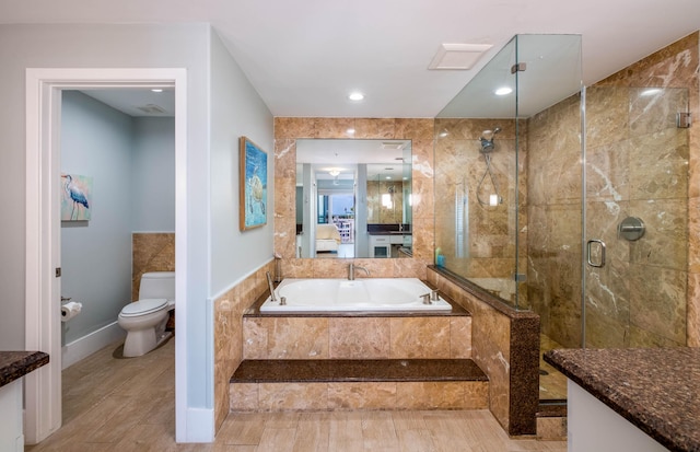 full bathroom with toilet, vanity, and shower with separate bathtub