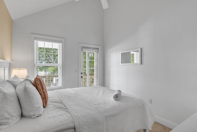 bedroom featuring lofted ceiling, access to outside, tile patterned floors, and ceiling fan