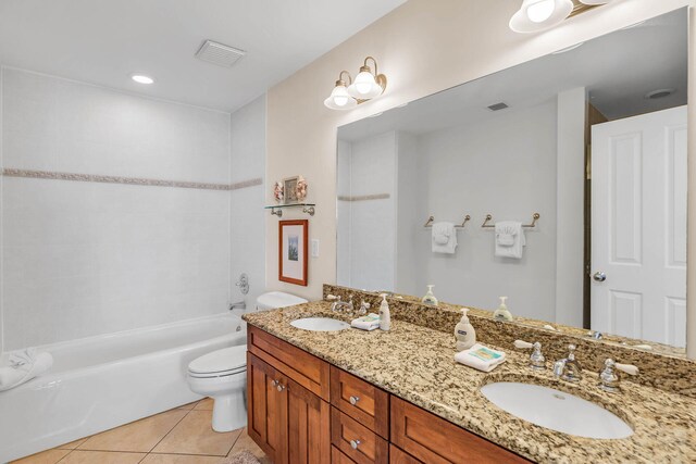 full bathroom featuring tile patterned floors, toilet, tiled shower / bath combo, and vanity