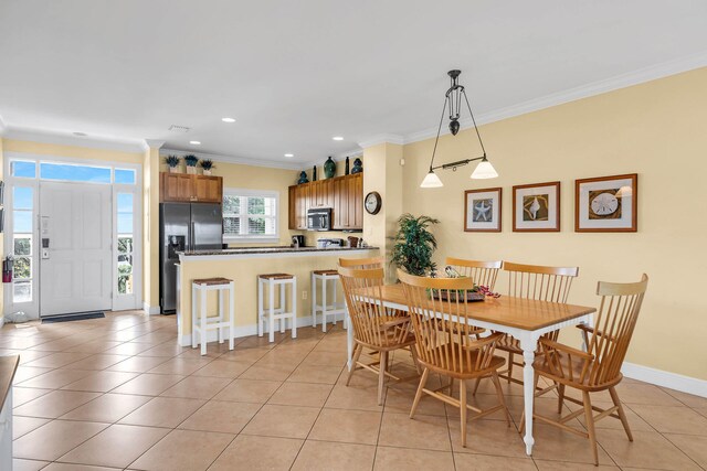 tiled dining room featuring crown molding