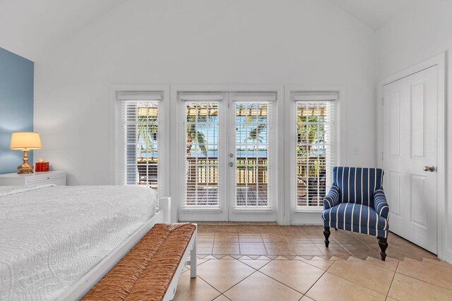 tiled bedroom with access to exterior and vaulted ceiling