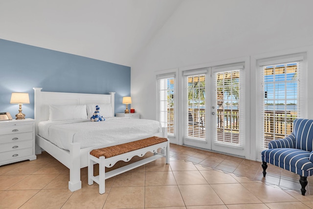 bedroom with light tile patterned floors, access to exterior, high vaulted ceiling, and french doors