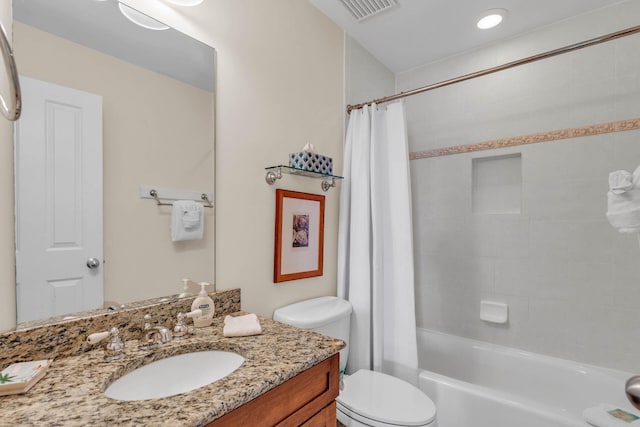 full bathroom featuring vanity, shower / bath combo, and toilet