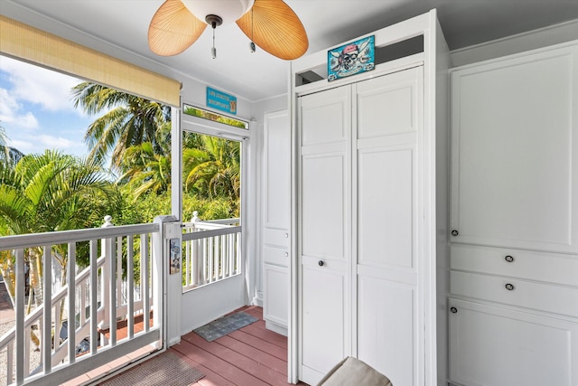 interior space featuring access to exterior, hardwood / wood-style floors, a closet, and ceiling fan