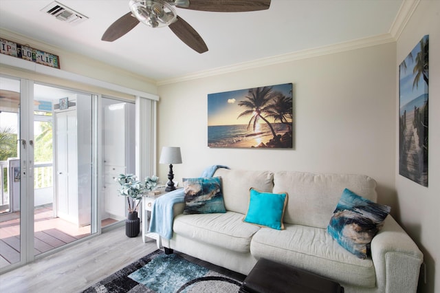 living room with hardwood / wood-style floors, crown molding, and ceiling fan