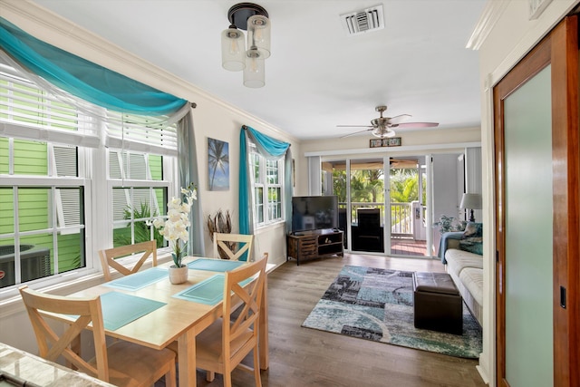 dining room with crown molding, hardwood / wood-style floors, and ceiling fan