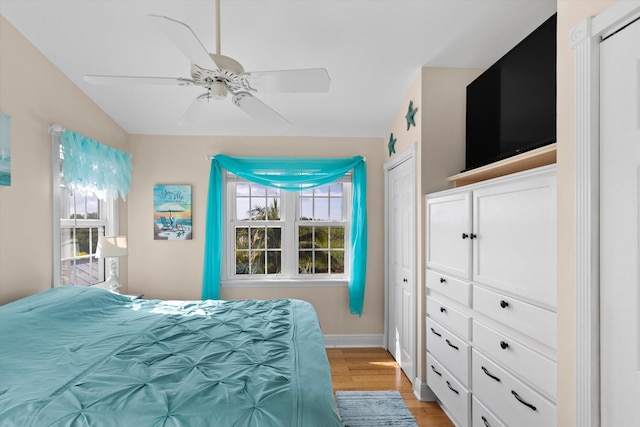 bedroom with ceiling fan and light wood-type flooring