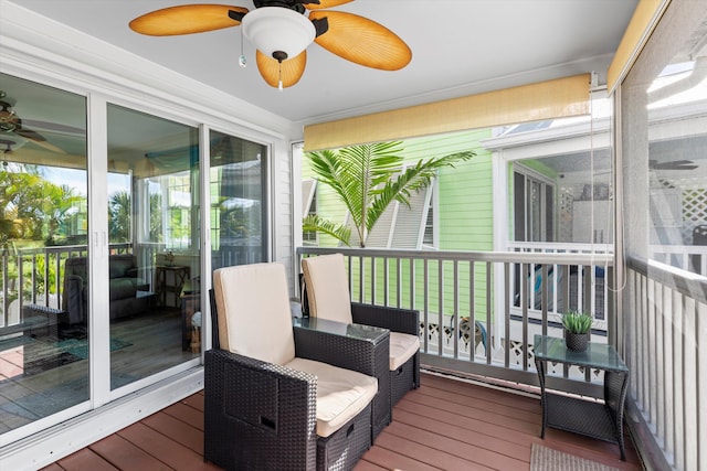 sunroom with a wealth of natural light and ceiling fan