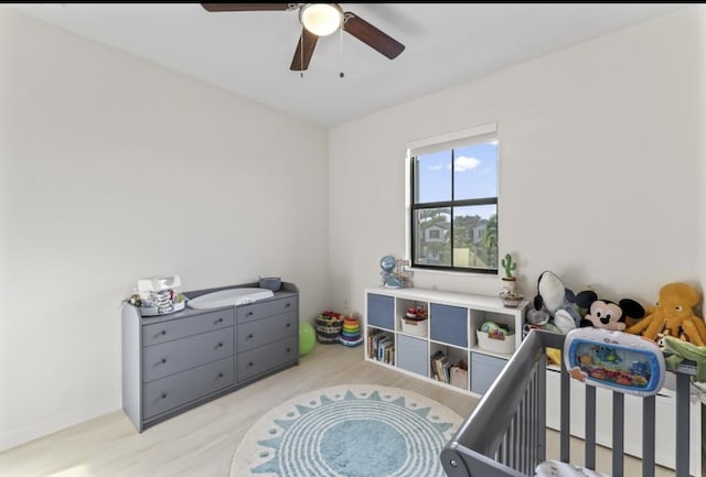 bedroom with ceiling fan and light wood-type flooring