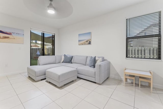 living room featuring light tile patterned flooring and ceiling fan