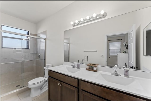 bathroom featuring vanity, a shower with shower door, tile patterned floors, and toilet