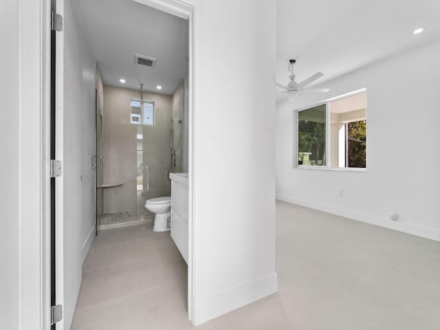 bathroom with an enclosed shower, ceiling fan, and toilet