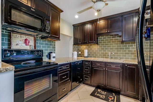 kitchen featuring light tile patterned flooring, sink, black appliances, light stone countertops, and dark brown cabinets