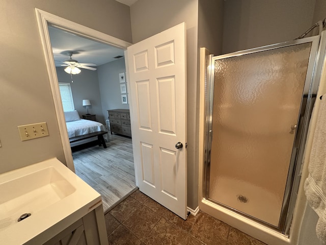 ensuite bathroom featuring ensuite bathroom, a stall shower, vanity, and a ceiling fan