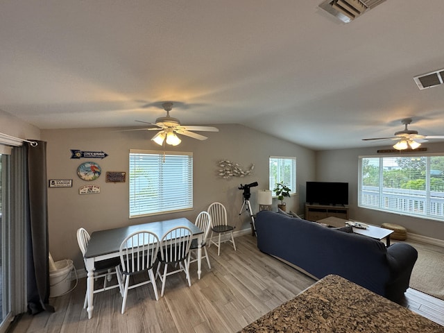 dining area featuring lofted ceiling, ceiling fan, light wood-type flooring, and visible vents