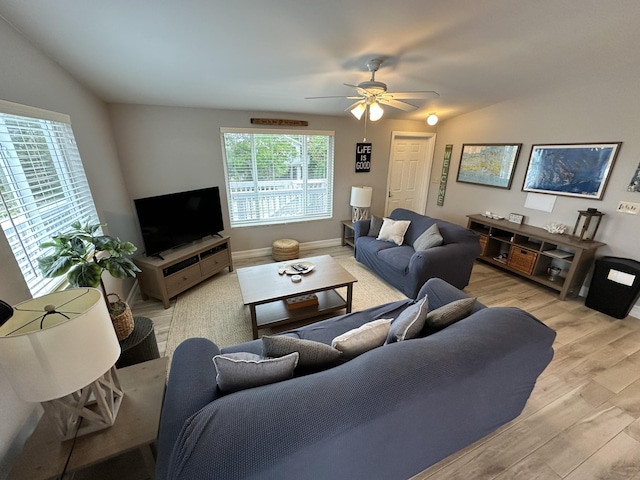 living room featuring a ceiling fan and light wood-type flooring