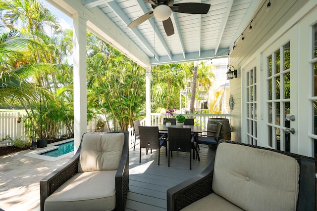223 Golf Club Dr, Key West, FL 33040 - wooden terrace with ceiling fan, outdoor dining space, a fenced in pool, and fence
