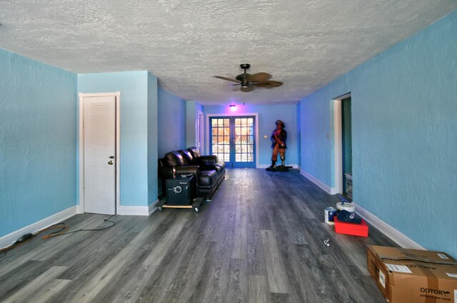 dining room featuring stacked washer and dryer, a textured ceiling, and ceiling fan