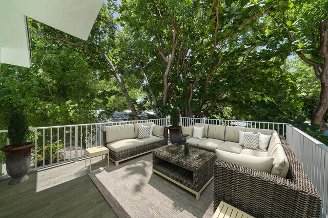 wooden terrace with an outdoor hangout area