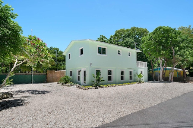 view of front of house with fence and stucco siding