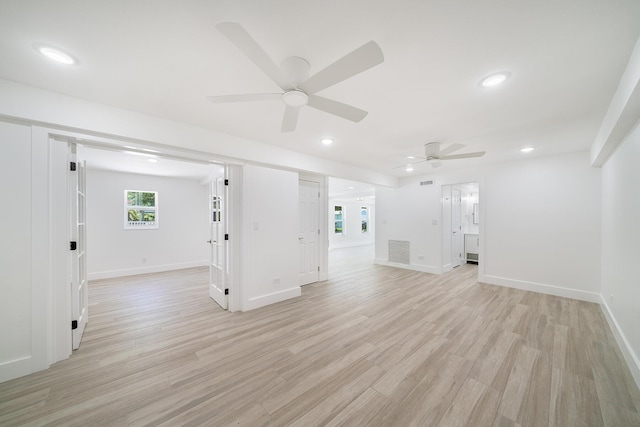 unfurnished living room with light wood-type flooring, visible vents, baseboards, and recessed lighting