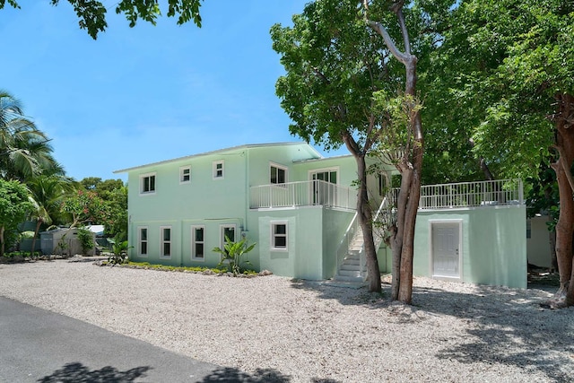 back of property featuring a balcony