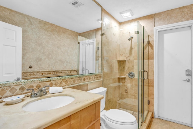 bathroom featuring tile walls, vanity, tasteful backsplash, toilet, and walk in shower