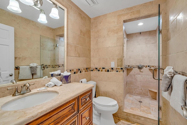 bathroom featuring vanity, tile walls, an enclosed shower, and toilet