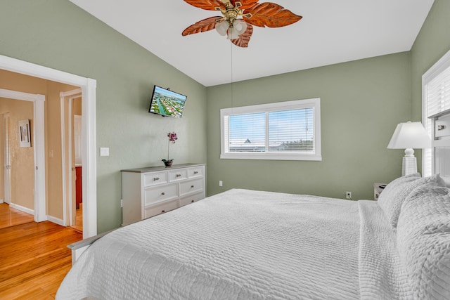 bedroom featuring multiple windows, ceiling fan, and light hardwood / wood-style floors