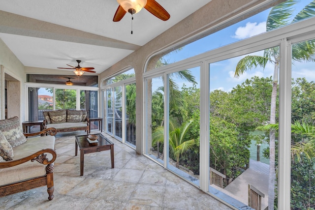 sunroom featuring ceiling fan