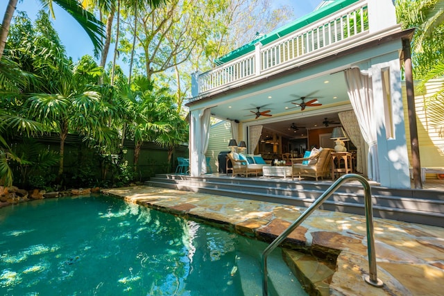 pool with a ceiling fan and a patio area