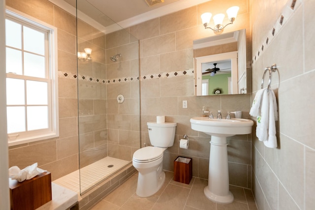 full bath featuring tile patterned floors, tile walls, toilet, and a walk in shower