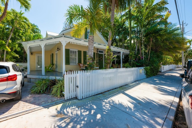 exterior space featuring a fenced front yard and covered porch